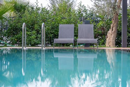 two chairs sitting next to a swimming pool at Villa with Private Swimming Pool in Bodrum in Bodrum City