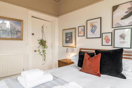 a bedroom with a bed and some pictures on the wall at 1869 - Room Only Boutique Townhouse in Ambleside