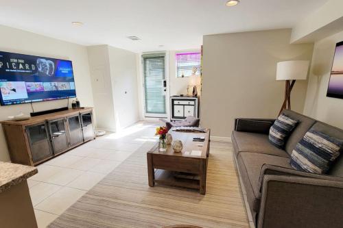 a living room with a couch and a tv at 14th 99 Walk Score 3 mins to Metro rail in Washington, D.C.