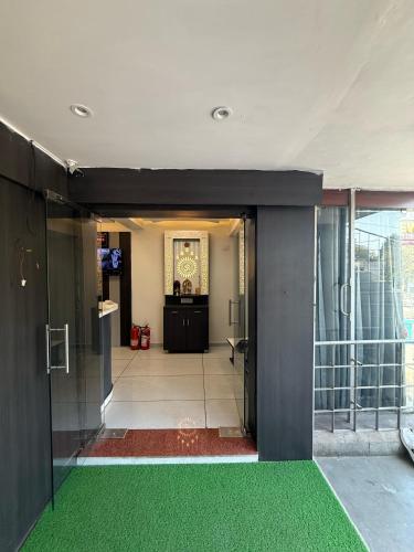 an entrance to a building with a green floor at Hotel Sunview in Ahmedabad