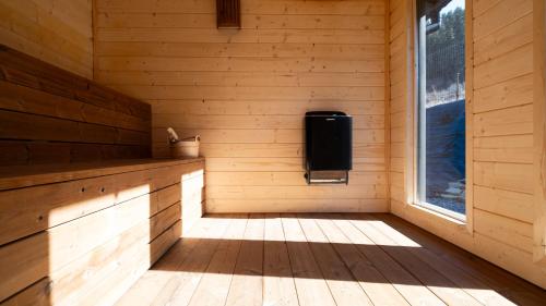 a room in a wooden cabin with a window at Ostoja Beskidy I, Sun & Snow in Szczyrk