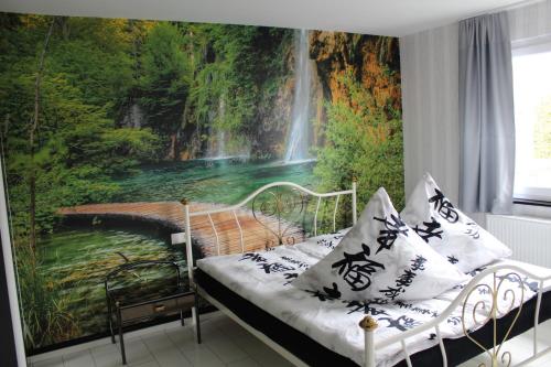 a bedroom with a view of a waterfall mural at Gästehaus Mama in Rust