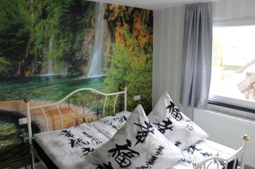 a bedroom with a bed with a waterfall mural at Gästehaus Mama in Rust