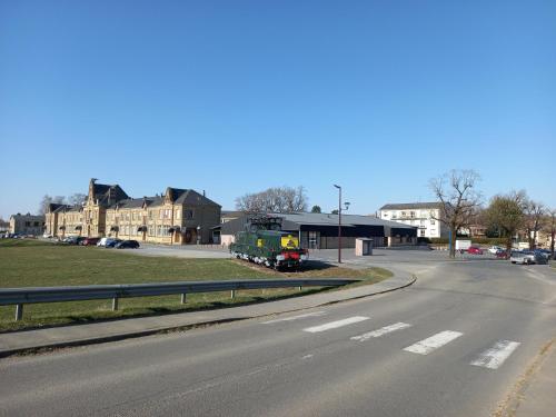 a train is parked on the side of a road at La locomotive by La BB12087 in Nouvion-sur-Meuse