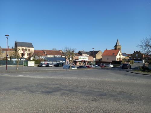 an empty parking lot in a town with houses at La locomotive by La BB12087 in Nouvion-sur-Meuse