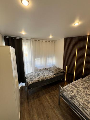 a bedroom with two beds and a window at Apartment Maja in Hungen