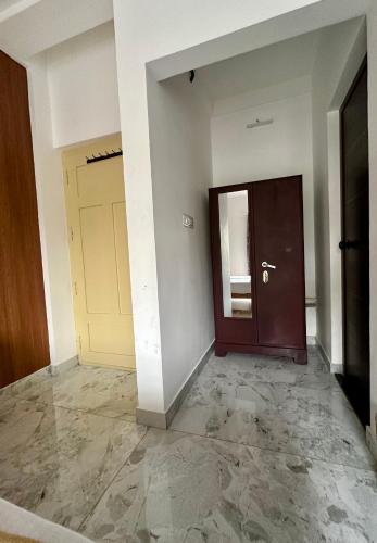 an empty room with a door and a hallway at M M Residency in Cochin