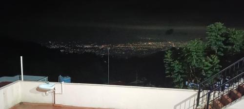 a view of a city from a balcony at night at Tn27callingkrishholiday in Yercaud