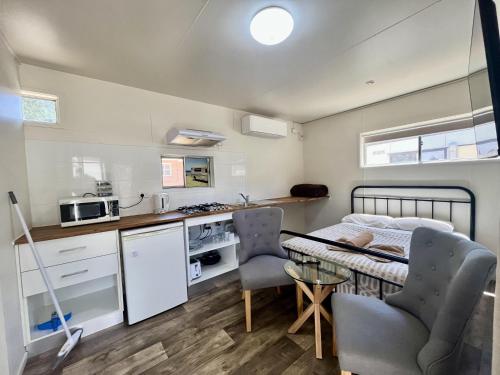 a small kitchen and dining room with a table and chairs at West View Caravanpark in Dubbo