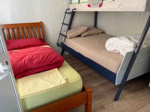 a bedroom with two bunk beds and a chair at Mahane in Tirana