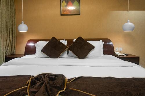 Ένα ή περισσότερα κρεβάτια σε δωμάτιο στο Anabel Apartment and Suites, Abuja