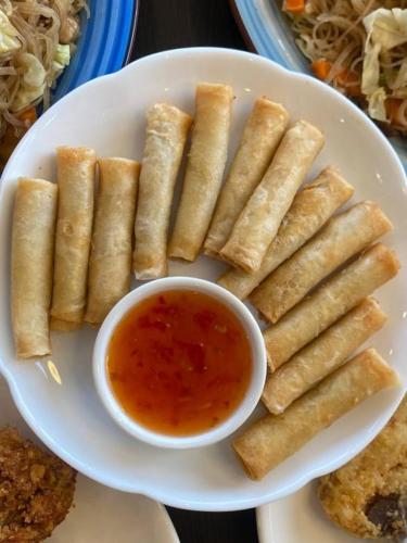 a plate of food with a bowl of dipping sauce at A & L Resort - Sea & Mountain View in Looc
