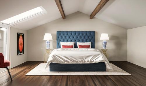 a bedroom with a large bed with a blue headboard at Charming House - O Mercado in Ponta Delgada