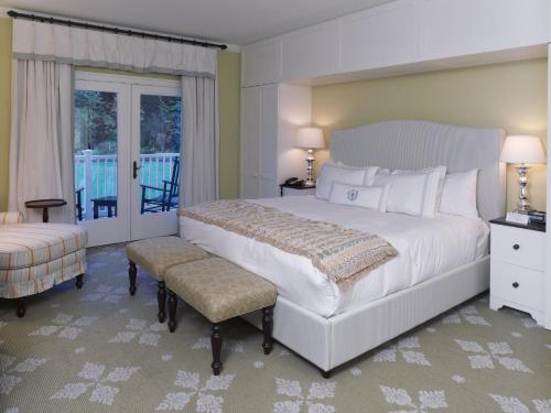 a bedroom with a large white bed and a balcony at Omni Bedford Springs Resort & Spa in Bedford