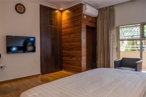 Ένα ή περισσότερα κρεβάτια σε δωμάτιο στο Anabel Apartment and Suites, Abuja