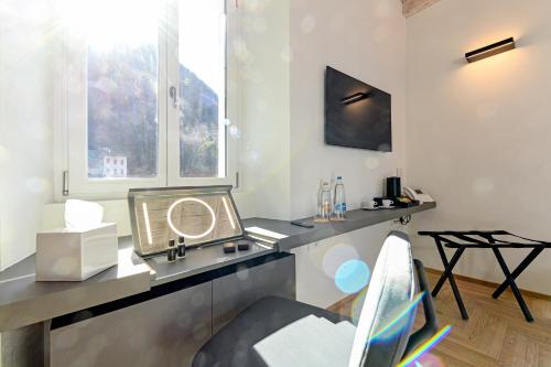 a room with a vanity with a mirror and a chair at Villa Rêverie - Boutique Hotel in Bellano