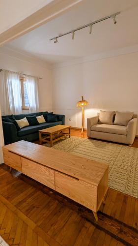 a living room with a couch and a coffee table at Mesaha I Madina Apt I 2min to Nile in Cairo