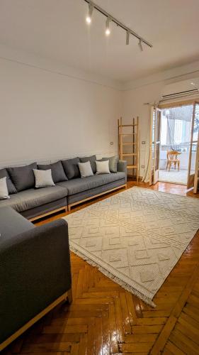 a living room with a couch and a rug at Mesaha I Madina Apt I 2min to Nile in Cairo