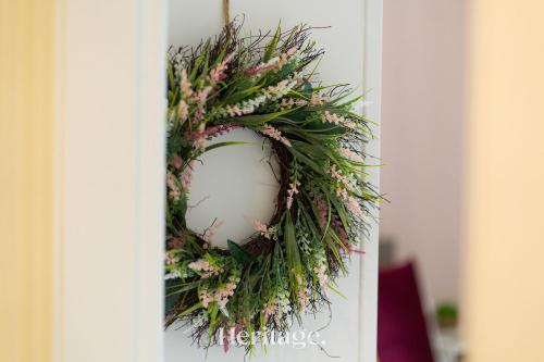 a wreath on a door with flowers on it at The Copper Loft Apartment, Keith in Keith