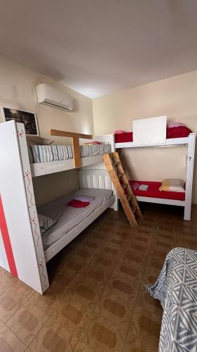 a room with three bunk beds in a room at Casa do Uai in João Pessoa