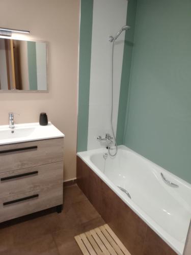 a bathroom with a bath tub and a sink at El Vergel del Piedra in Munébrega