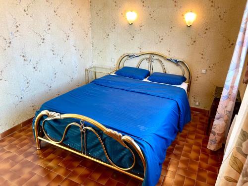 Cette chambre comprend un lit avec des draps bleus et des oreillers bleus. dans l'établissement Grand Appartement Provençal, à Manosque