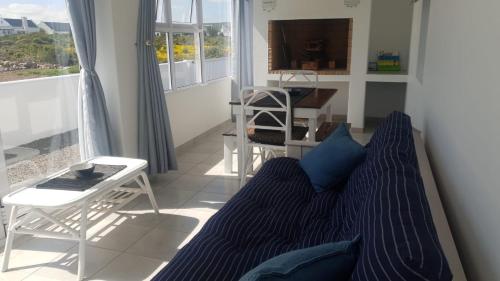 a living room with a couch and a table at Jacobsdaller #1 in Jacobs Bay