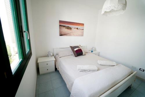 Postel nebo postele na pokoji v ubytování Villetta Le Dune