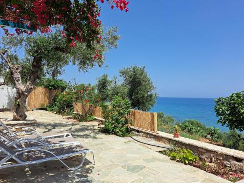 a group of chairs sitting next to the ocean at Blue Fox 1 in Chrani