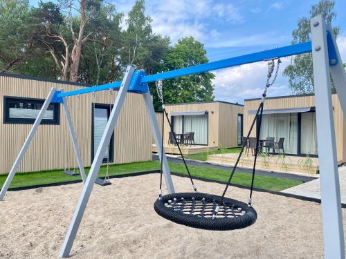 a tire swing in a playground at Resort Hel domki letniskowe in Hel
