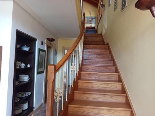 a winding staircase with wood treads in a home at La Casa Malvarrosa in Ampuero