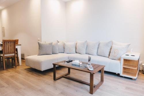 a living room with a white couch and a coffee table at The Suites near AUC by Elegant Hospitality in Cairo
