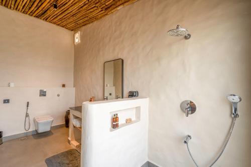 a bathroom with a shower and a toilet at KURJA Jawai in Bīsalpur