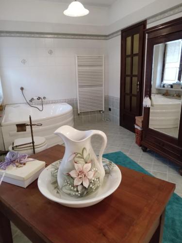 a white vase on a table in a bathroom at Bed and Breakfast di Nonna Piera in Casalborgone