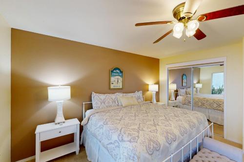 a bedroom with a bed and a ceiling fan at Hip Nautic in Rockaway Beach