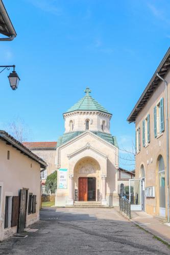 an old building with a clock tower on a street at Wellin'Ars in Ars-sur-Formans