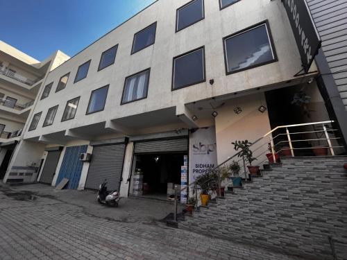 a building with stairs in front of a building at Sanjit Royal Stay in Mussoorie