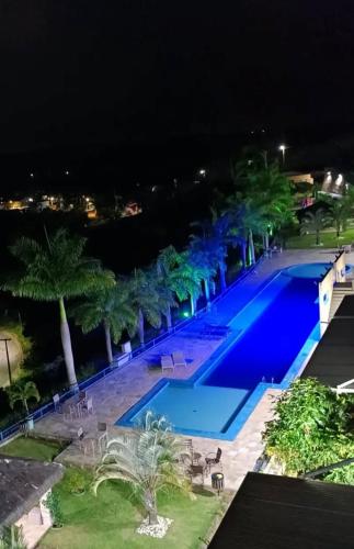 a view of a swimming pool at night at Flat no Condomínio Alto da Serra Villas in Bananeiras