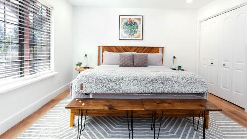 a bedroom with a bed and a wooden table at Arrowleaf Family House with Hot Tub in Kanab