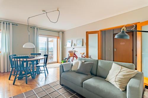 a living room with a couch and a table at Terraço da Linha - Bairro Calmo e Central in Aveiro