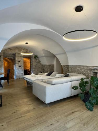a bedroom with two beds and a stone wall at Rustico cota in Tignale