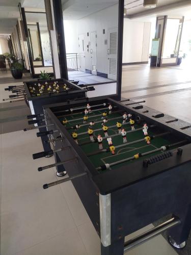 a row of billiard tables in a room at The Orabella 27F Chill Zone with a View in Manila