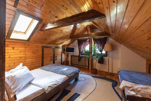 a bedroom with a bed in a wooden cabin at Casa Valasoaia in Săcele