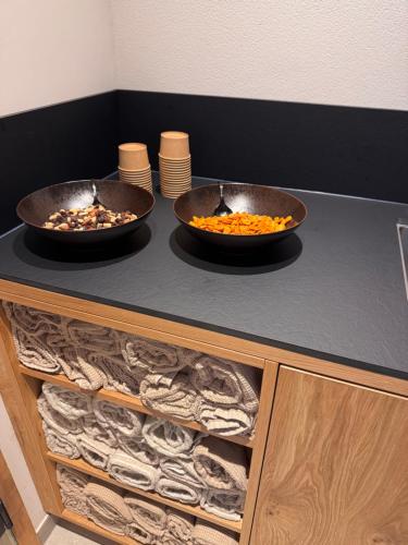 two bowls of food sitting on top of a counter at LH Suites Aparthotel - NEW since 2025 in Saalbach Hinterglemm