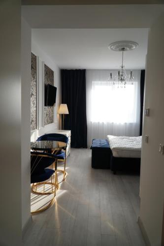 a living room with a table and a bed at Royal Elegance Apartment in Bucharest