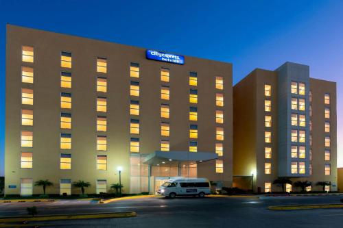 a hotel with a van parked in front of it at City Express by Marriott Aguascalientes Sur in Aguascalientes