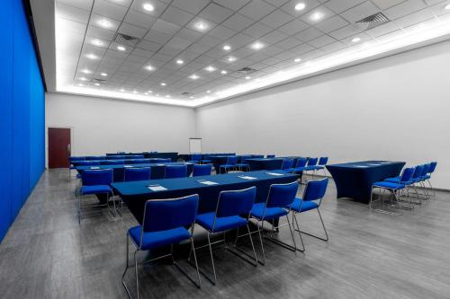 a conference room with blue tables and blue chairs at City Express by Marriott Aguascalientes Sur in Aguascalientes