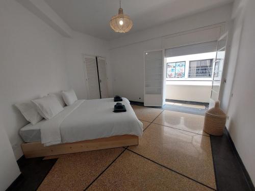a bedroom with a bed and a large window at Dar Collon in Tangier