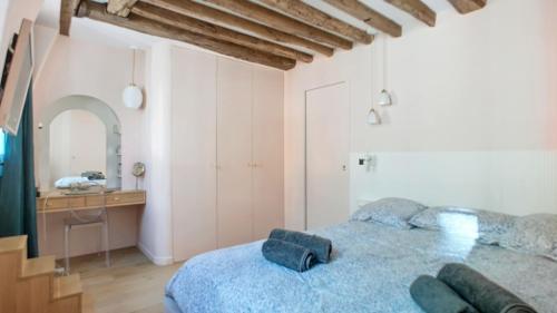 - une chambre avec un lit bleu et un bureau dans l'établissement Chic à la Parisienne, Central Paris - Marais, à Paris