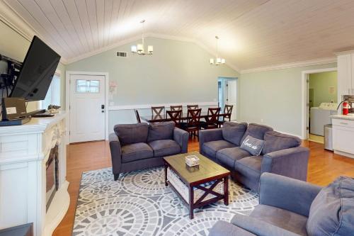 a living room with two couches and a table at Seaside Comforts in Seaside